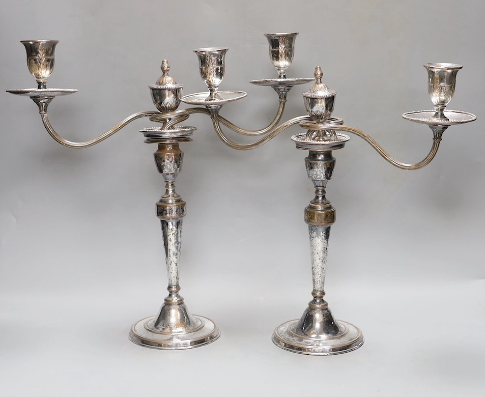 A pair of Sheffield plate two-branch twin-light candelabra, 37 cms high.
